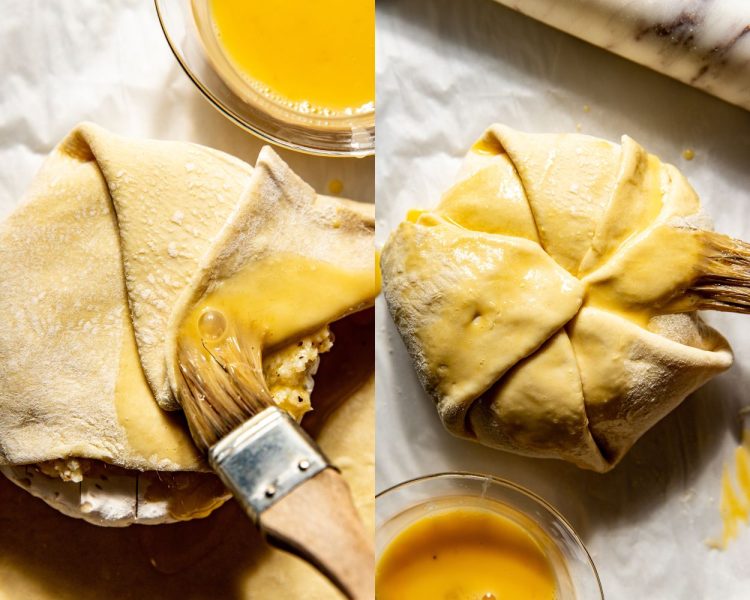 Side by side images. Left side shows puff pastry being folded over wheel of brie and a brush adding an egg wash on each fold. Right side shows the full brie wheel covered with the folded puff pastry and finished with egg wash all over.