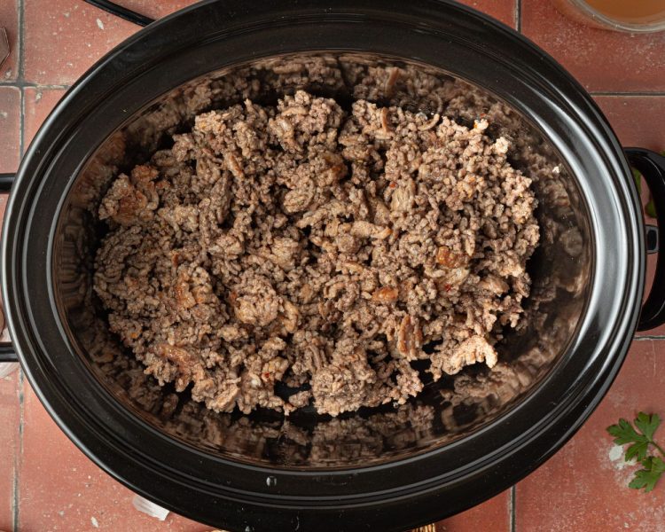 ground beef and ground italian sausage cooked, in black crock pot