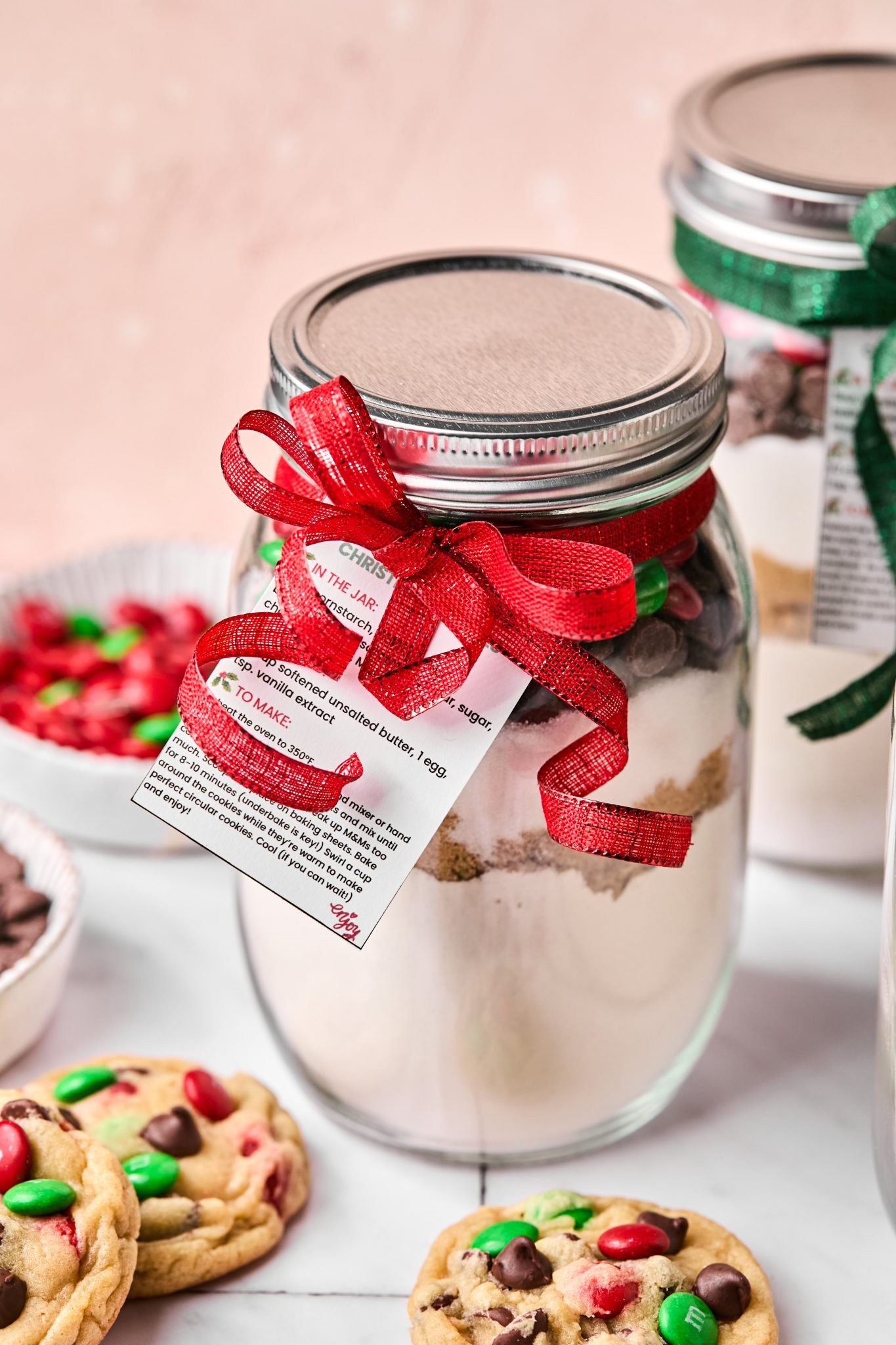 cookie mix in a glass mason jar with a red ribbon attached. 