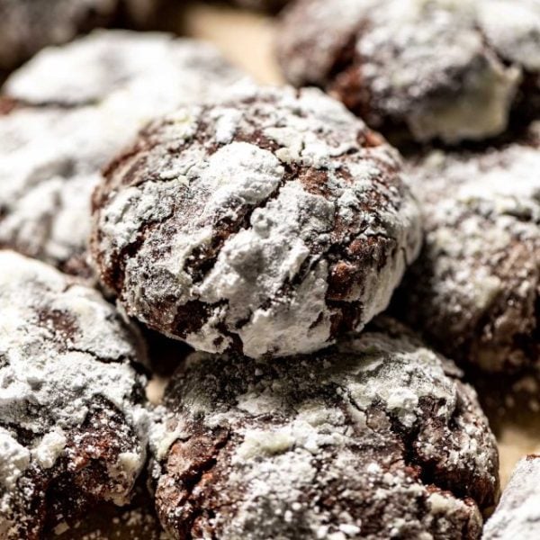 close up of several chocolate crinkle cookies.
