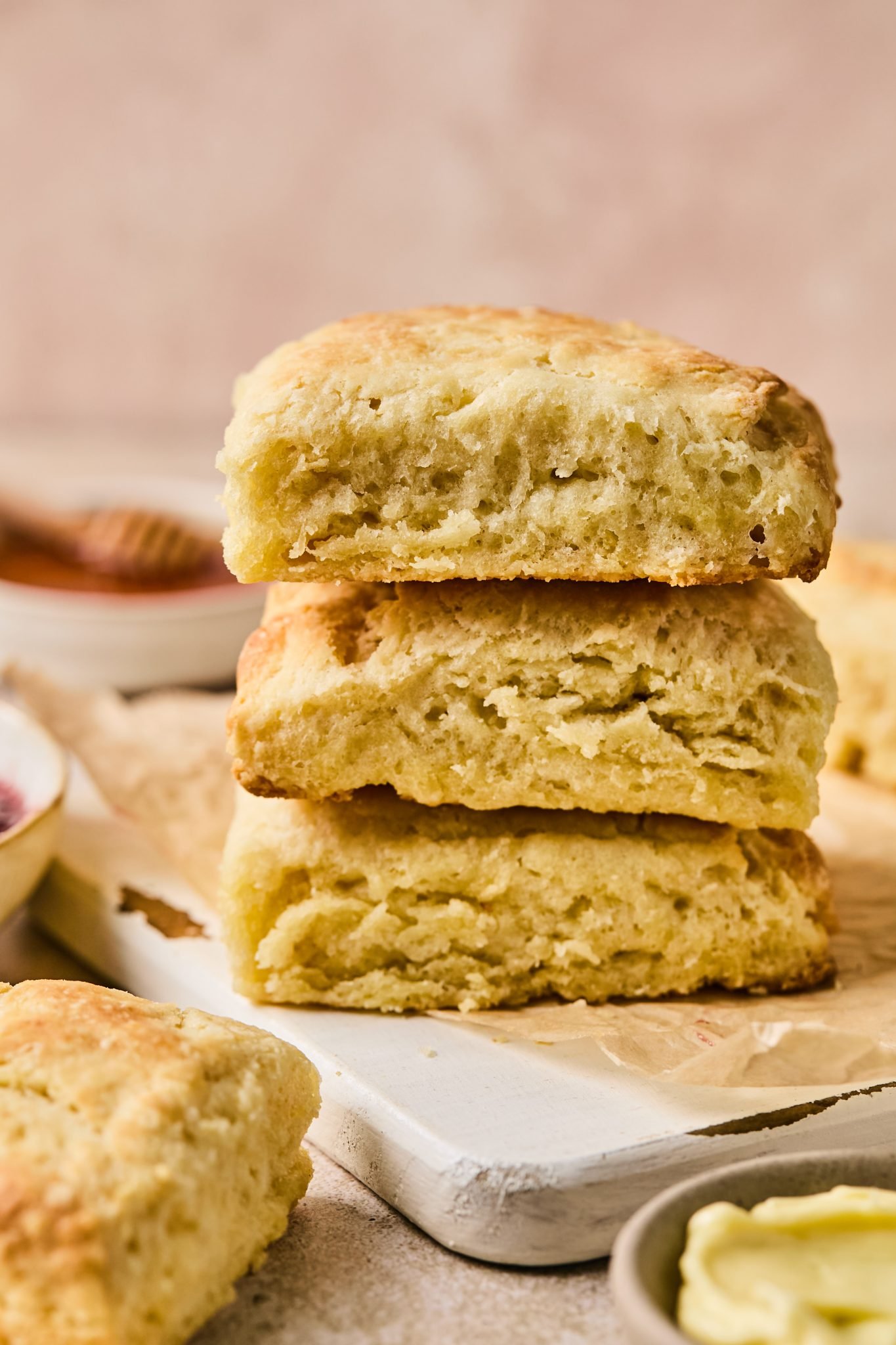 a stack of buttermilk biscuits on parchment paper. 