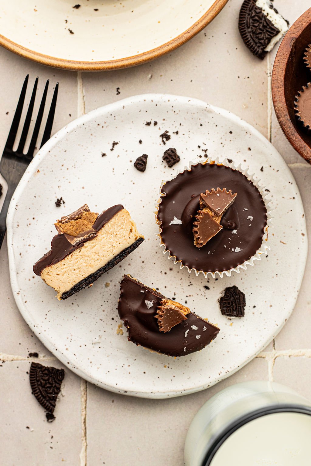 One full circle shaped mini cheesecake plus two halves. Topped with chocolate, half reeses cup, and flaky sea salt.