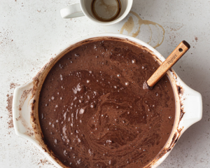 White mixing bowl with chocolate cake batter.