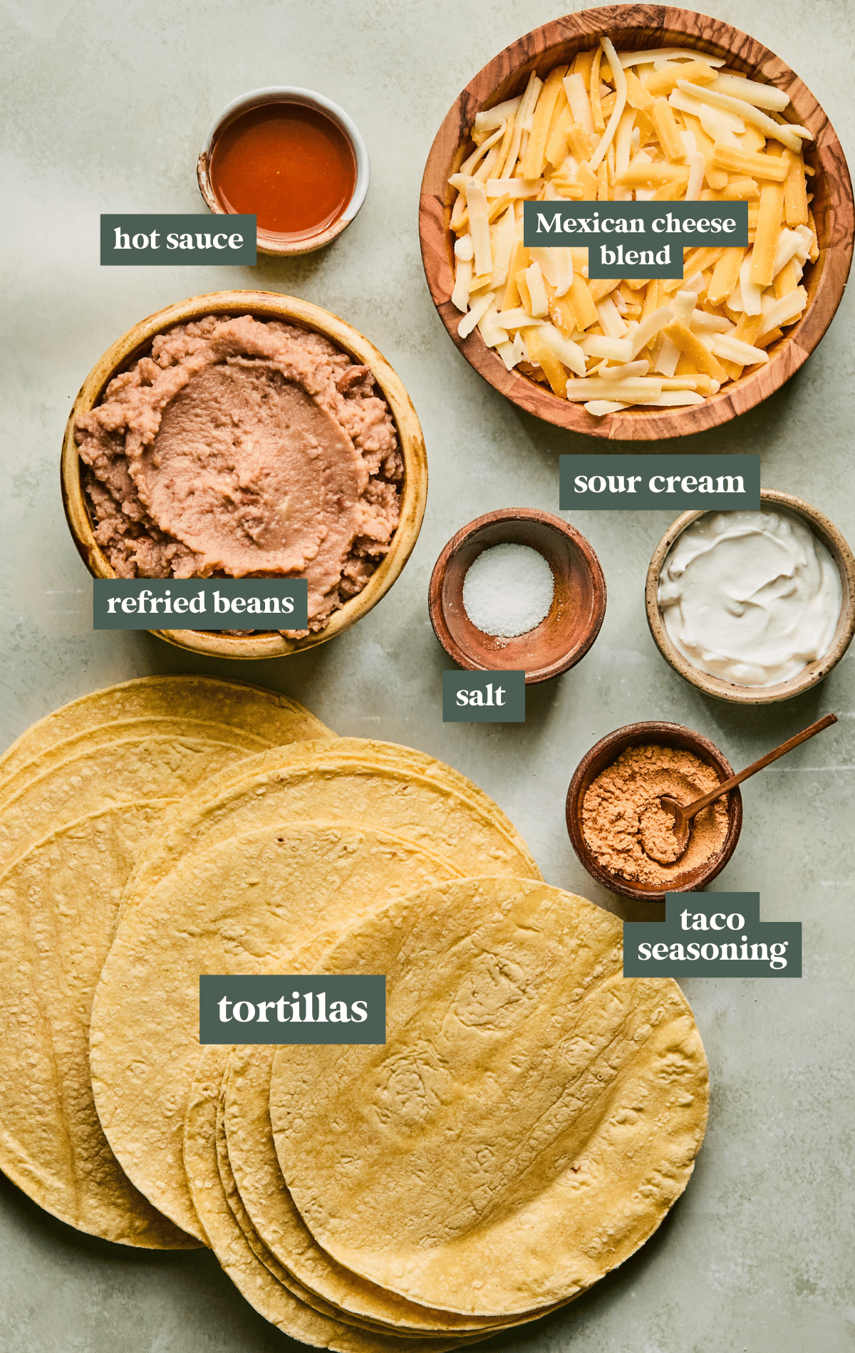 ingredients to make taquitos in small wooden bowls. 