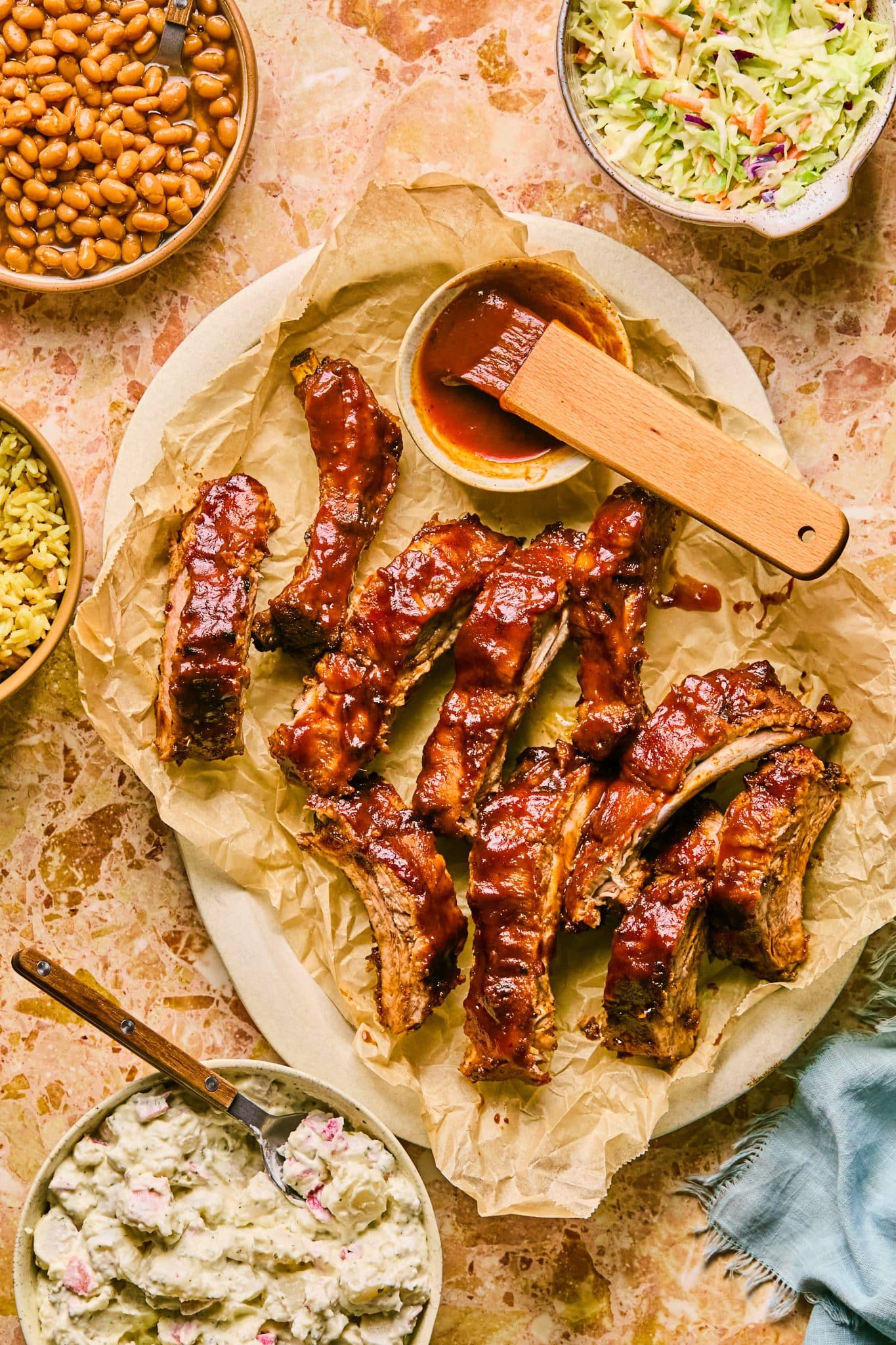 pork ribs with bbq sauce all over them on a plate. 