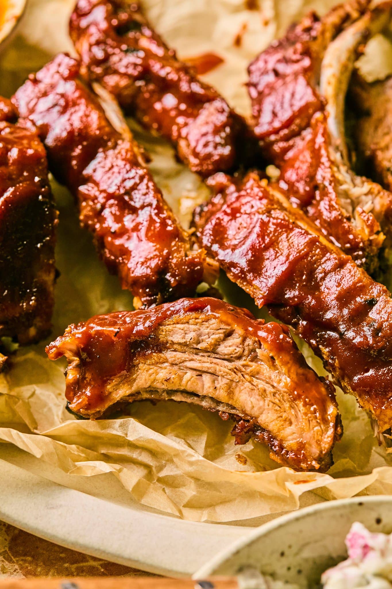 a close up image of pork ribs slathered in bbq sauce. 