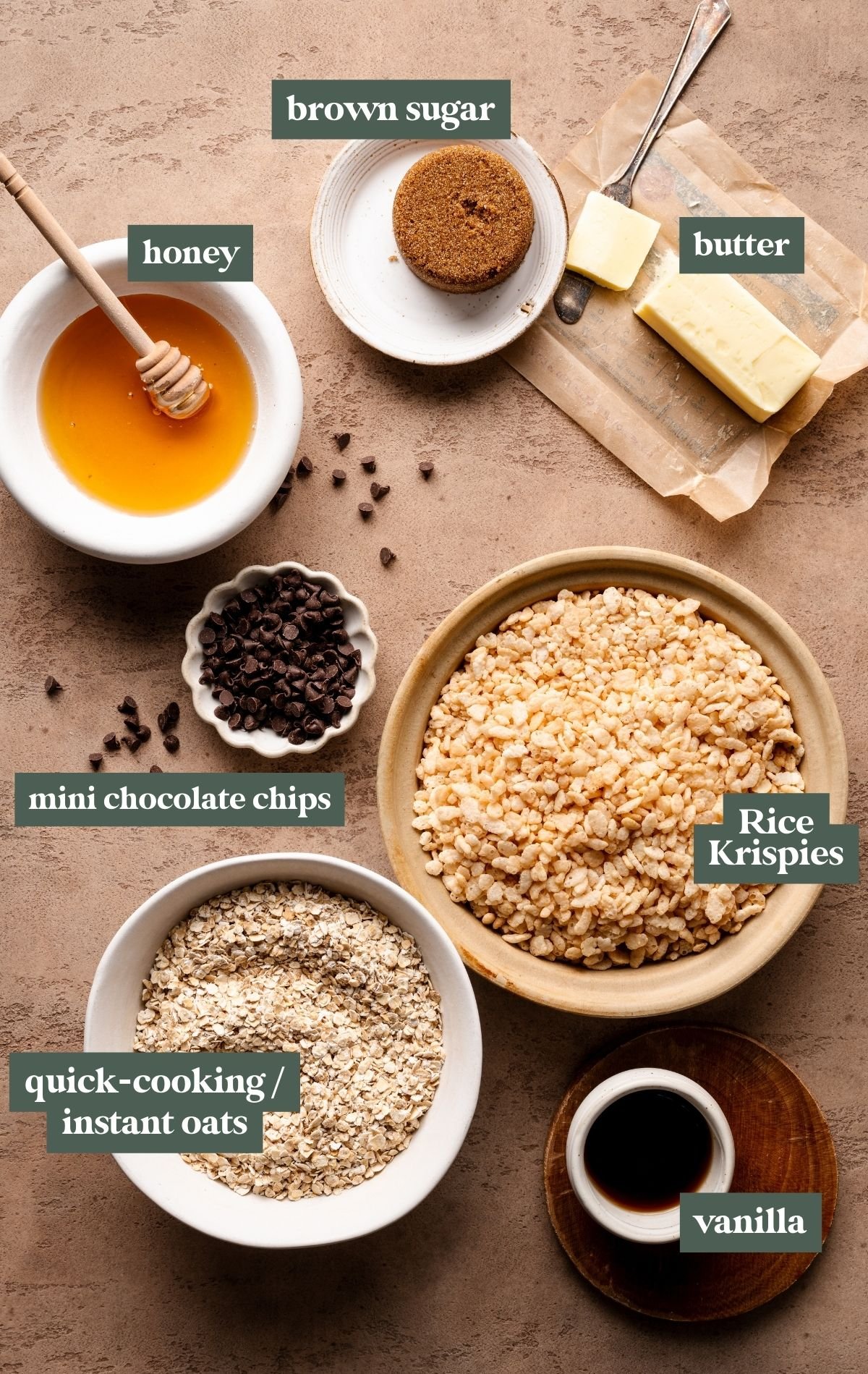 ingredients needed to make homemade granola bars in small glass bowls. 