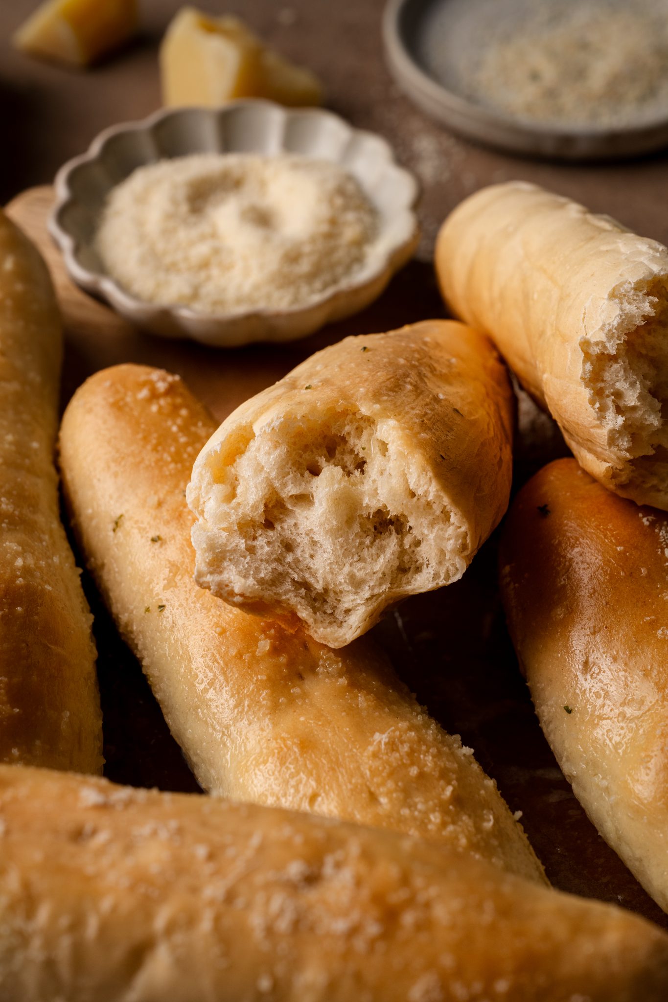 a close up image of a breadstick with a bite taken from it. 