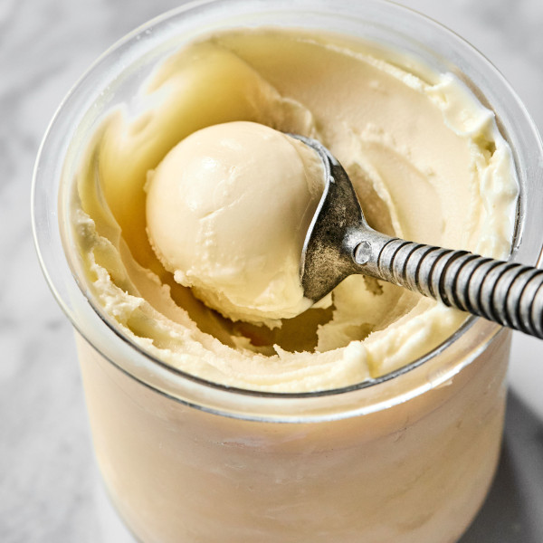 Scooping vanilla ice cream out of ninja creami after spinning before adding mix-ins.