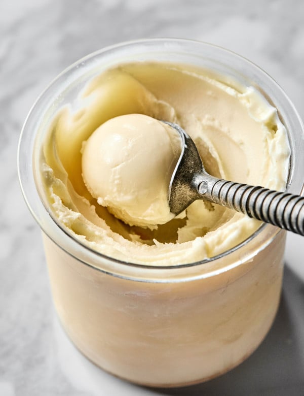 Scooping vanilla ice cream out of ninja creami after spinning before adding mix-ins.