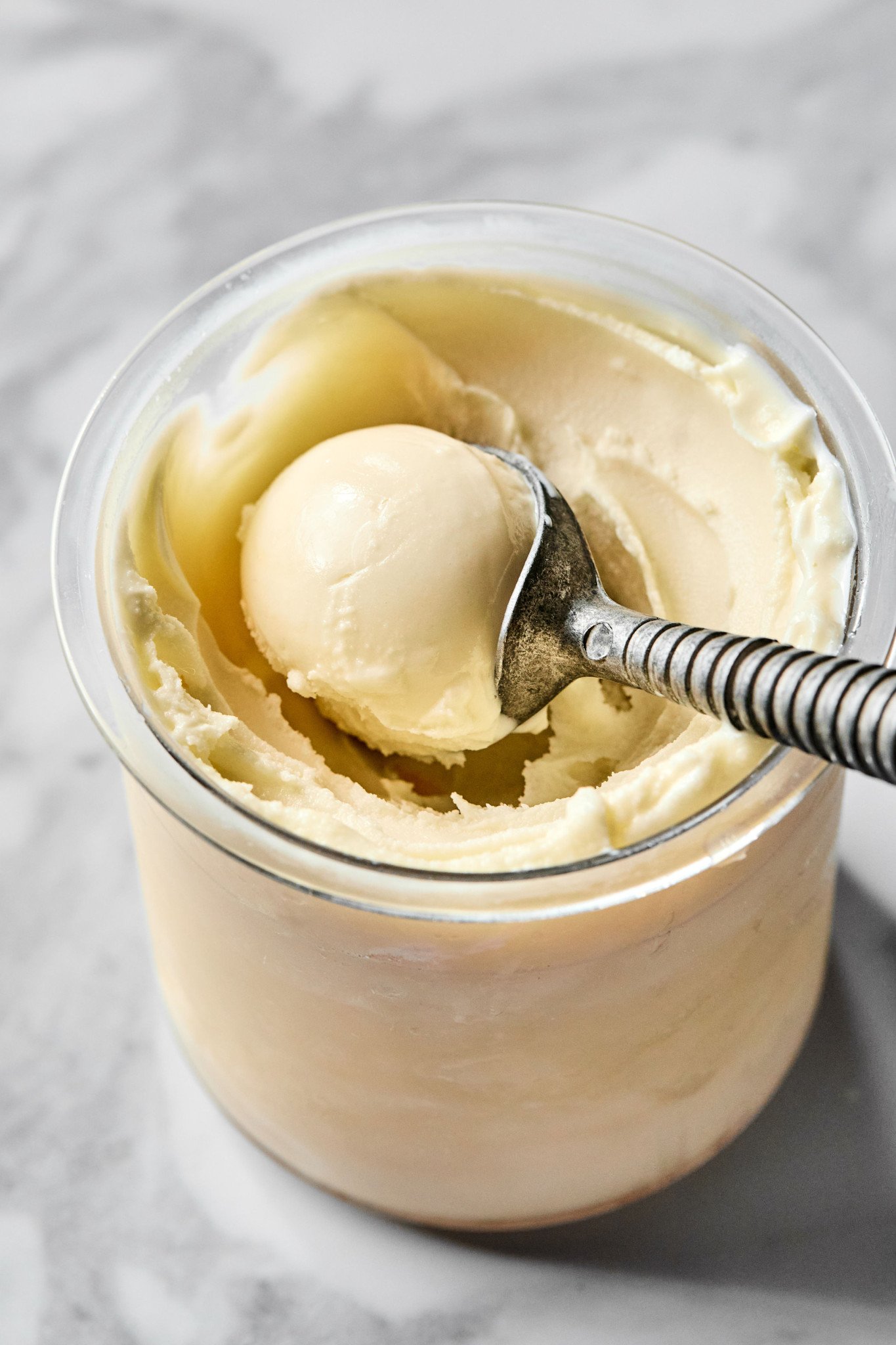 Scooping vanilla ice cream out of ninja creami after spinning before adding mix-ins.