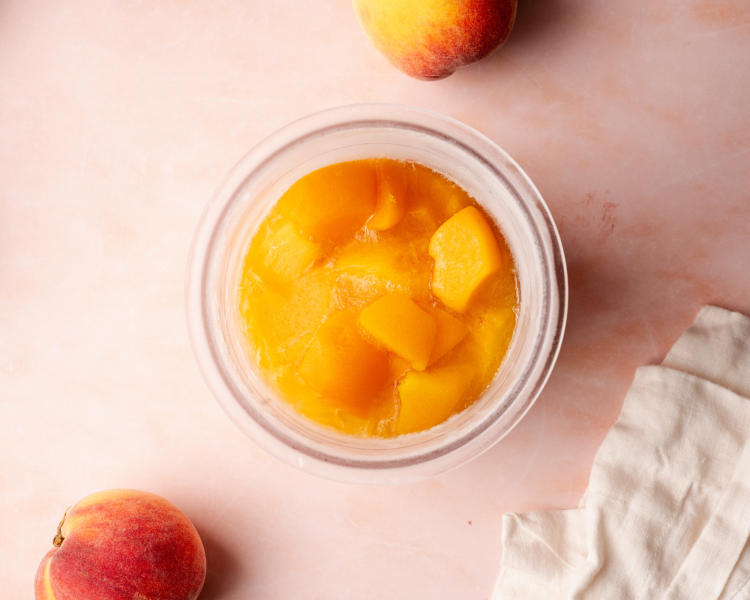 Peach chunks frozen in ninja creami pint container.