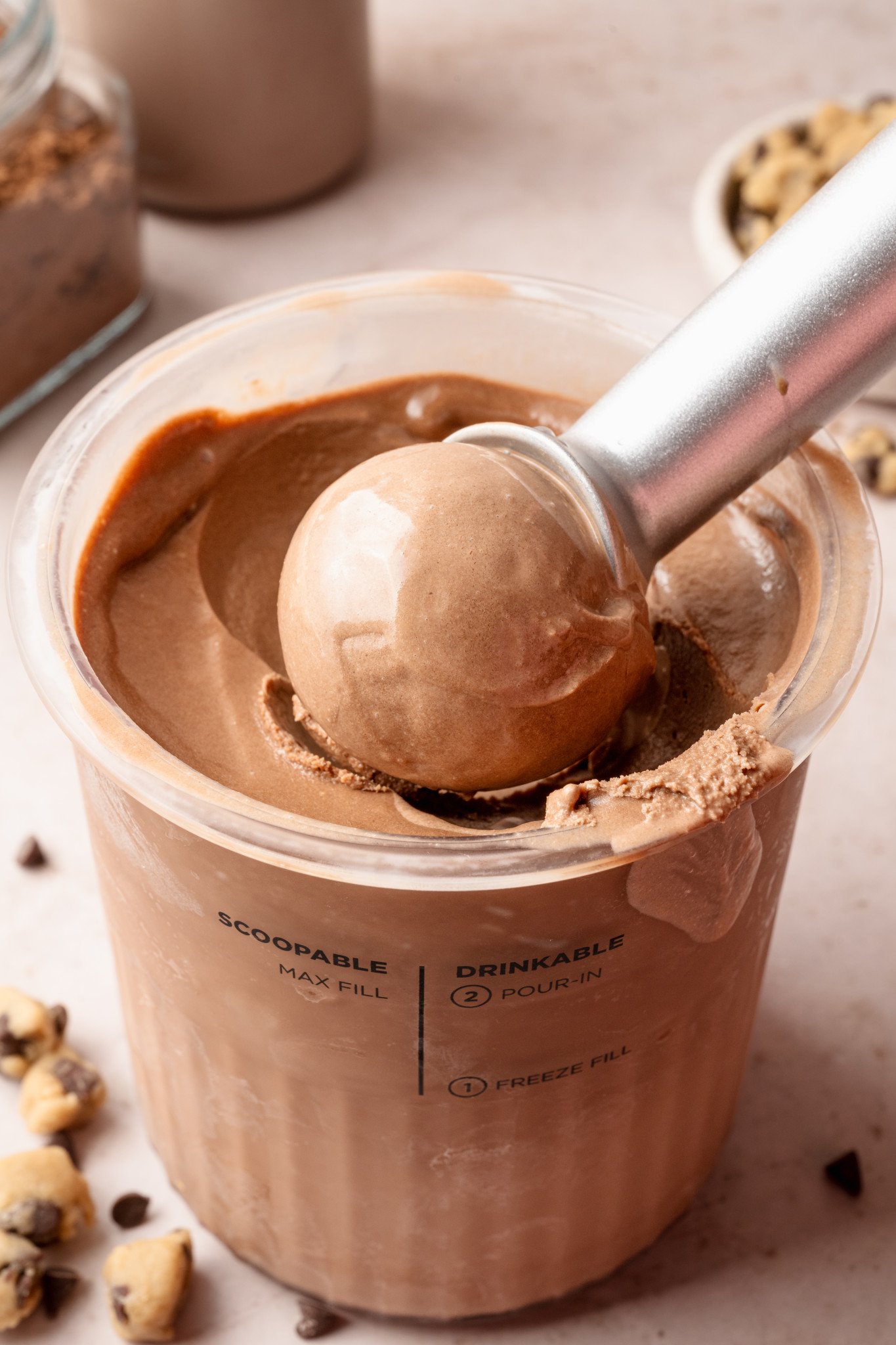 Scooping chocolate ice cream out of ninja creami pint container.