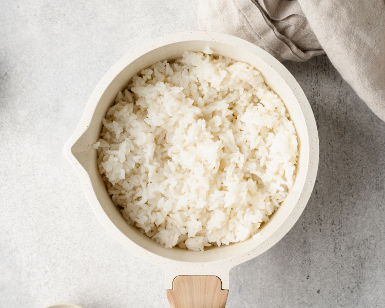 Cooked rice in small saucepan for ahi tuna poke bowls.