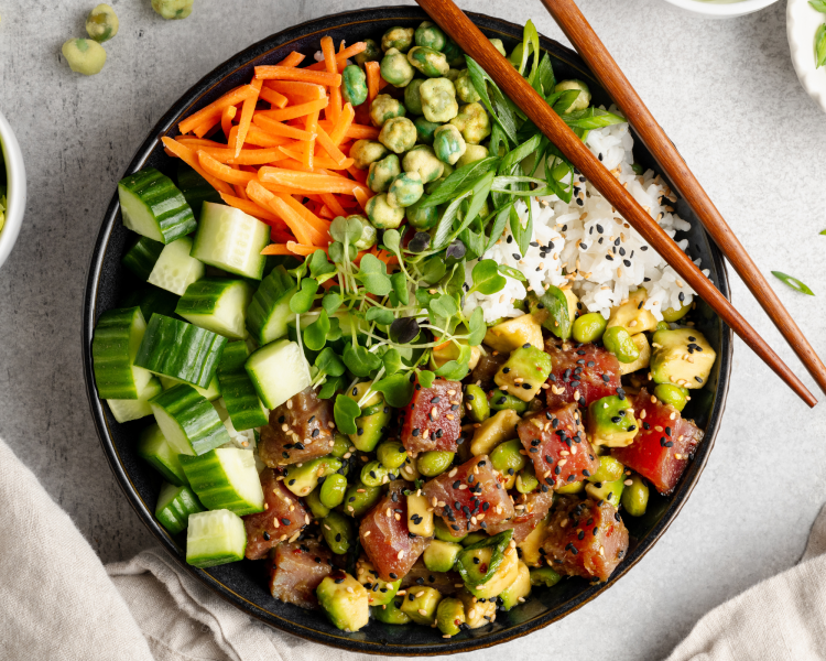 Fully assembled ahi tuna poke bowl in large bowl with chopsticks on the side.