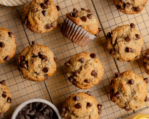 Chocolate chip banana muffins cooling on wire rack after baking.