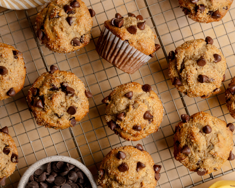 Chocolate chip banana muffins cooling on wire rack after baking.