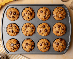 Banana chocolate chip muffins baked in muffin tin.