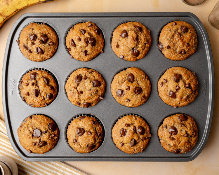 Banana chocolate chip muffins baked in muffin tin.