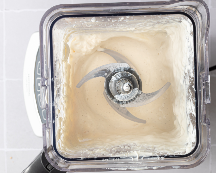 Ninja creami vanilla frozen yogurt base blended together in a blender.