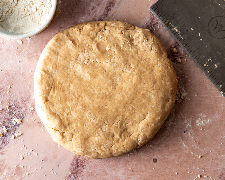 Cinnamon scone dough formed into circle.