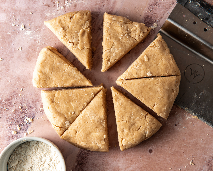 Cinnamon scone dough cut into 8 triangles.