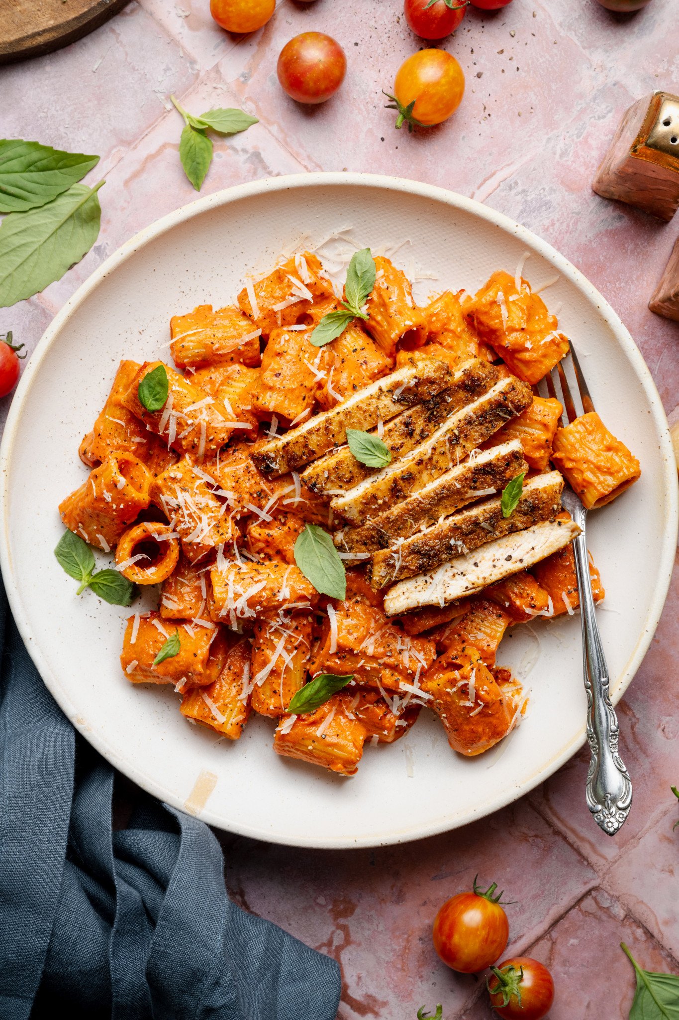 Spicy voda pasta with chicken on white plate with fork.