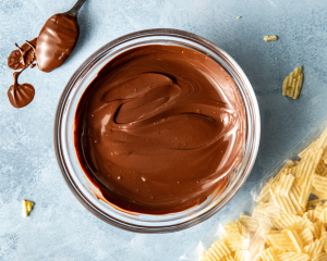 Chocolate melted in glass bowl.