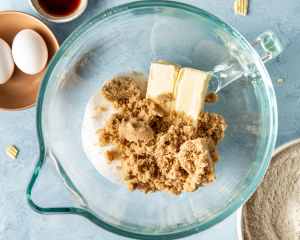 Adding the butter and sugars to mixing bowl.