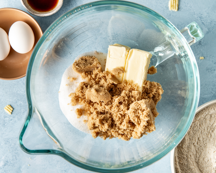 Adding the butter and sugars to mixing bowl.