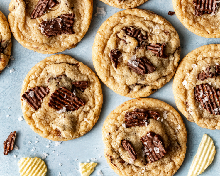 Baked chocolate potato chip cookies topped with extra chocolate chips and sea salt.