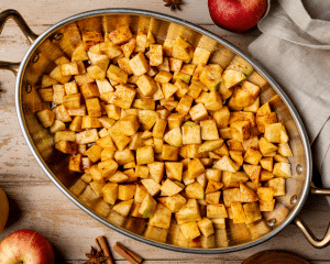 Apple mixture spread into an even layer in the bottom of a baking dish.