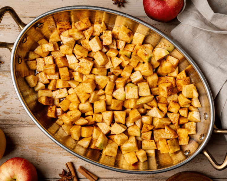 Apple mixture spread into an even layer in the bottom of a baking dish.