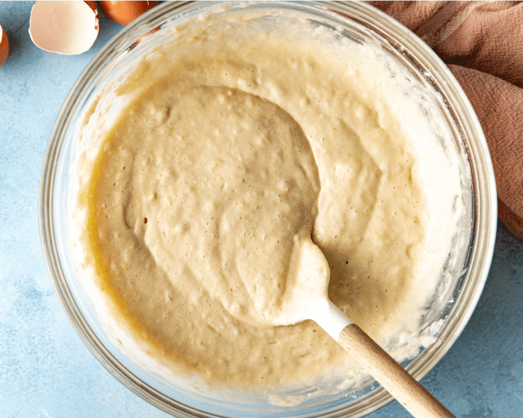 Waffle batter mixed in a bowl that is resting for 10 minutes before cooking.