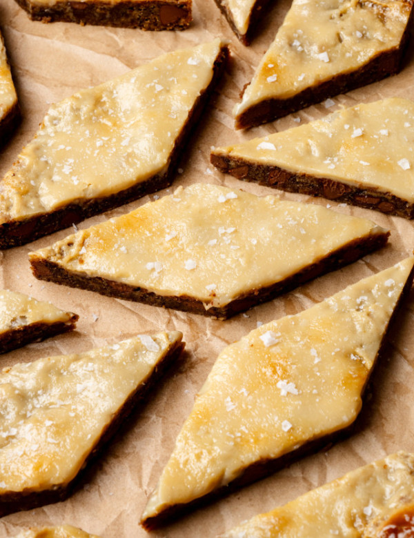 Coffee cookie bars cut into diamond shapes sprinkled with salt.