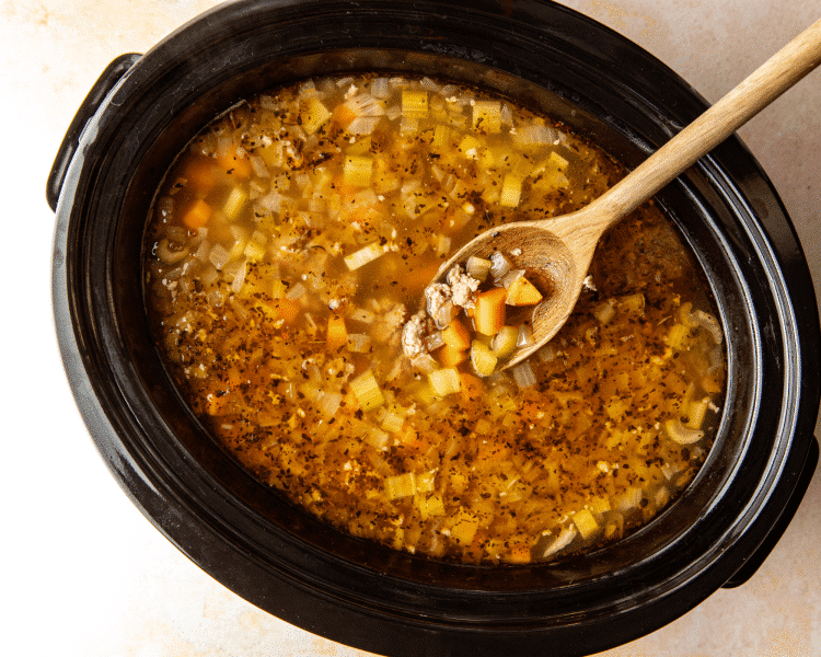Soup cooked in slow cooker before adding kale.