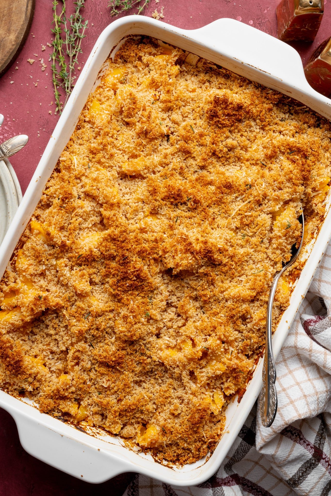 Sweet potato mac and cheese baked in a 9x13 baking dish.