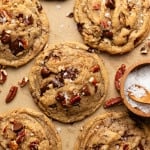 Brown butter pecan chocolate chip cookies baked and topped with extra pecans and flaky sea salt.