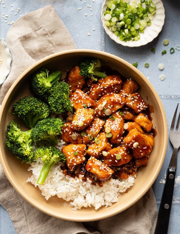 Honey garlic chicken in bowl with rice and broccoli.