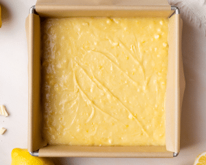 Lemon brownie batter poured into an 8x8 pan.