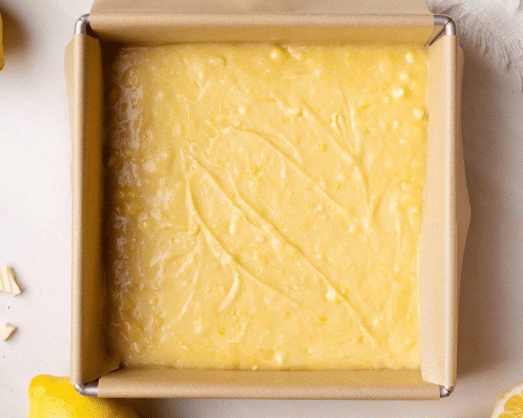 Lemon brownie batter poured into an 8x8 pan.
