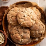 Giant snickerdoodle cookies stacked in bowl.