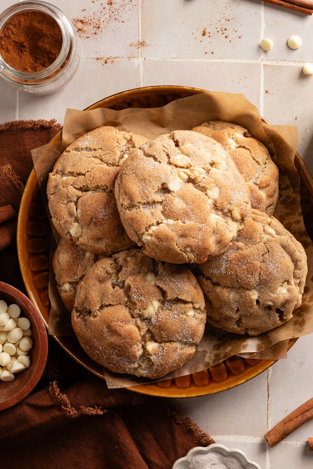 Giant snickerdoodle cookies stacked in bowl.