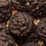 Black and white chocolate chip cookies baked and placed on parchment paper.