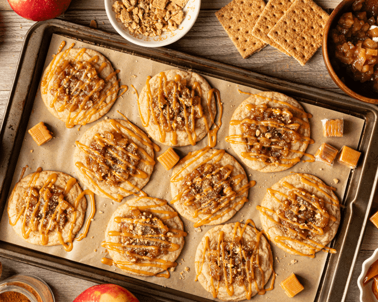 Apple pie cookies drizzled with caramel and sprinkled with graham cracker crumbs to finish off.
