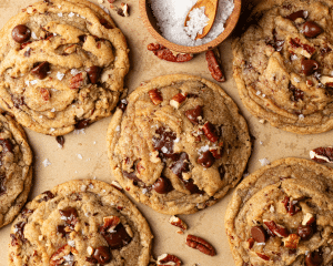 Brown butter pecan chocolate chip cookies baked on parchment paper.