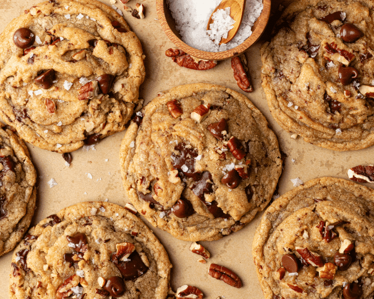 Brown butter pecan chocolate chip cookies baked on parchment paper.