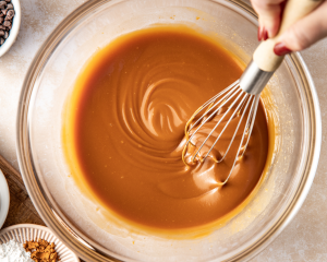 Whisking the melted butter and cookie butter in mixing bowl.