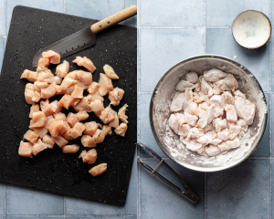 Side-by-side image of dicing chicken into bite-size pieces then tossing in cornstarch.