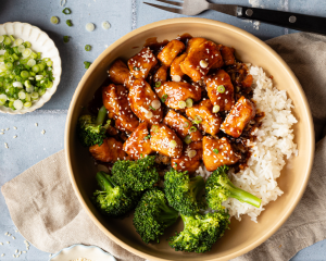 Honey garlic chicken in bowl with rice and broccoli.